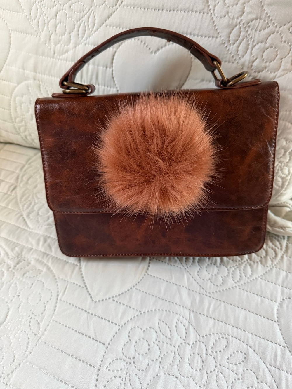 Brown Leather-Look handbag with Brown Fur Pom Accent.